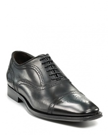 Sleek oxford with perforated upper and cap toe.