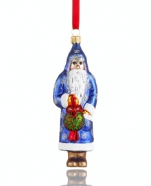 You just might catch Mommy kissing Santa Claus. With a kissing ball in-mitten, Father Christmas peers innocently out of his sparkle-studded robe in this glass Vaillancourt ornament.