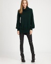 Masterful example of effortless elegance, this lengthy turtleneck of pure cashmere has long bishop sleeves and a split hem. TurtleneckLong bishop sleevesSplit hem hits below the hipsCashmereDry cleanImportedModel shown is 5'10 (177cm) wearing US size Small. Additional Information Women's Premier Designer & Contemporary Size Guide 