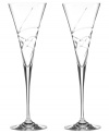 A fanciful cut pattern contrasts the timeless silhouette of Adorn crystal toasting flutes, featuring the exquisite craftsmanship of Lenox.