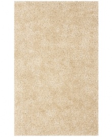 Add rich, shimmering ivory texture to any modern room with the Metallic area rug from Dalyn. Hand-tufted of soft polyester, this high-luster shag area rug puts comfort and fun back in floor decor.