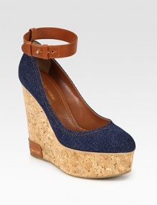 Comfortable cork wedge with a stretch denim upper and an adjustable leather ankle strap. Cork and leather wedge, 5 (125mm)Cork platform, 2 (50mm)Compares to a 3 heel (75mm)Denim and leather upperLeather liningRubber solePadded insoleMade in Spain