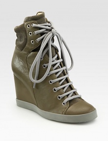 Lace-up leather hi-top sneakers revitalized by soft suede trim and a towering wedge. Self-covered wedge, 3¼ (80mm)Leather and suede upperLeather liningRubber solePadded insoleImportedOUR FIT MODEL RECOMMENDS ordering one half size up as this style runs small. 