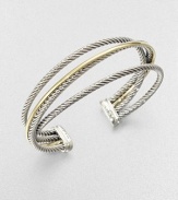 An iconic style with a crossover design featuring sleek sterling silver cables accented with radiant 18k gold. Sterling silver18k goldDiameter, about 2.5Slip-on styleImported 