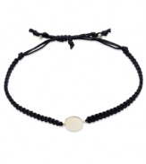 Wrap-ably chic! This trendy bracelet features a polished 14k gold disc strung from a black nylon rope cord. Approximate diameter: 2-1/4 inches (extends to 3-1/2 inches).