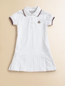 Soft, airy pique knit with sporty stripes, perfect for your future tennis star.Ribbed polo collar with two-color striped tippingShort sleeves with ribbed, tipped cuffsButton placketLogo appliqué at chestDropped waist with box pleated skirt96% cotton/4% elastaneMachine washImported Please note: Number of buttons may vary depending on size ordered. 