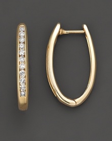 A channel set row of brilliant diamonds ignite this stunning oval hoop earring in 14 Kt. yellow gold.