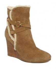 Show off your mountain-top fashion sense in the Kaisy wedge booties by Ivanka Trump. Fitted with a soft shearling trim and stacked to the heights with gorgeous suede, they're sure to heat up your winter wardrobe.