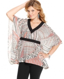 Jessica Simpson pairs a bold abstract print with poncho design on a top that adds optimal style to your day look!