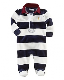 A comfortable footed coverall in plush velour features a preppy rugby stripe and collar for a timeless sporty look.