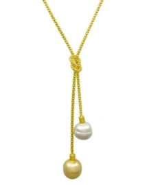 From the island of Mallorca, Spain, this love knot lariat pendant features white and champagne organic man-made baroque pearls (14 mm) set in 18k gold over sterling silver. Approximate length: 16-18 inches. Approximate drop: 1 inch.