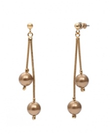 Add a simple touch of luxury in rich, golden hues. Monet earrings feature two, bronze-plated resin pearls strung on delicate chains crafted in gold tone mixed metal. Approximate drop: 2-1/2 inches.