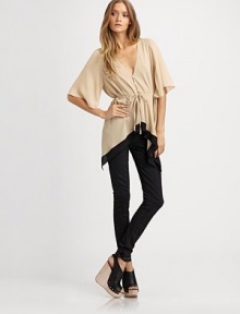 Utterly-romantic in a draped silk button-down, finished with flutter sleeves and a contour hem.V necklineShort sleevesButton-down frontSelf-beltContrast stripe at hemGathered pleats at backAbout 24 from shoulder to hemSilkDry cleanImported