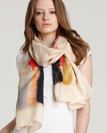 A luxurious silk scarf with an abstract watercolor-like print.