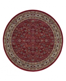 Inspired by the lovely Sarouk carpets of ancient Persia, this round rug features an intricate floral motif in ivory, sage green and accents of soft blue against a rich red ground.