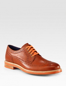 Sharp detailing, contrasting colors and allover perforations makes this sleek oxford design one step ahead of the rest.Leather upperLeather liningPadded insoleRubber soleImported