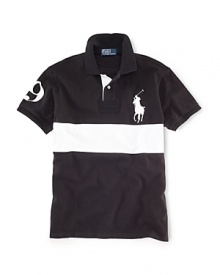 A short-sleeved polo shirt is cut for a trim, athletic-looking fit from durable cotton mesh with a bold stripe at the chest for a cool, color-blocked style.