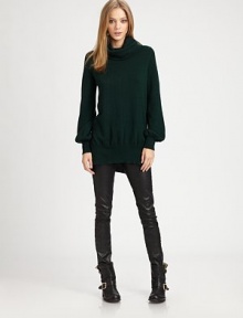 Masterful example of effortless elegance, this lengthy turtleneck of pure cashmere has long bishop sleeves and a split hem. TurtleneckLong bishop sleevesSplit hem hits below the hipsCashmereDry cleanImportedModel shown is 5'10 (177cm) wearing US size Small. Additional Information Women's Premier Designer & Contemporary Size Guide 