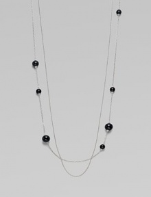 A long, delicate piece with beautiful round black agate stations on one of the two sterling silver link chains. Black agateSterling silverLength, about 39¾Clasp closureImported 