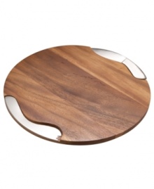 Nambe sculpts rich acacia hardwood into the ideal cheese cutting board, carved with precise storage nooks for the knife and spreader. Minimalist stainless steel utensils with lasting gleam stay put magnetically when they're not busy slicing and serving. This collection of cheese boards is designed by Neil Cohen.