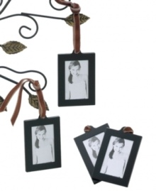 Mini metal picture frames on a leather strap swing from branches of your Christmas tree, on a bulletin board or in your bedroom window. Coordinates with the Leeber Family Tree.