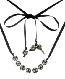 Be queen of the disco and bring the party wherever you go. Betsey Johnson's flashy design features seven sparkling fireballs strung on a delicate black ribbon. Ribbon ends decorated with fireball and charm accents. Crafted in black-plated mixed metal. Approximate length: 32 inches.