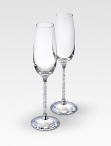 A pair of delicate, elegant and very festive flutes are made for special occasions in clear crystal with faceted crystal stems that adds an element of romance to any evening. Each, 10H X 2¾ diam. Hand wash Made in Austria