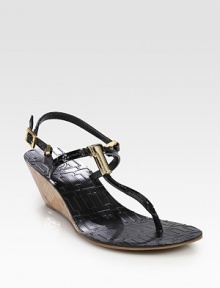 Patent leather t-strap with a natural cork wedge, goldtone T embellishment and adjustable straps. Cork-covered wedge, 2 (50mm)Patent leather upperLeather liningRubber solePadded insoleImportedOUR FIT MODEL RECOMMENDS ordering true size. 