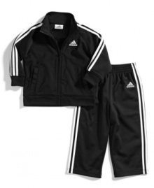 Warm up. He can keep comfy when he's on-the-run with this jacket and pants set from adidas, perfect for playtime.