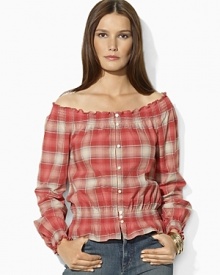 A soft woven cotton top channels western inspiration with a faded plaid pattern and smocked detailing.