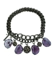 Eye-catching and eclectic. Chic cylindrical charms and faceted glass accents in a rich purple hue add distinctive detailing to Kenneth Cole New York's stretch bracelet. Crafted in mixed metal, the stretch design lets it slip on and off with ease. Includes a signature gift box. Approximate length: 7-1/2 inches.