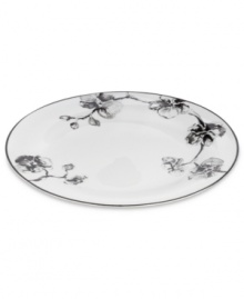 Compose a striking arrangement with the Black Orchid dinner plate by Michael Aram. Fine white Limoges porcelain flourishes under a dark watercolor motif inspired by foliage from around the world.