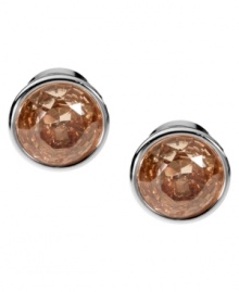 Smoky hues captivate the senses. Michael Kors' elegant stud earrings boast round-cut smoky topaz-colored cubic zirconia set in silver tone mixed metal. Approximate diameter: 1/2 inch.