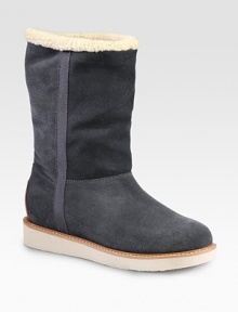 Ultra-cozy suede essential lined in shearling with grosgrain ribbon trim. Rubber heel, 1 (25mm)Shaft, 9¼Leg circumference, 13Pull-on styleSuede upper with grosgrain ribbon trimShearling liningRubber solePadded insoleMade in Italy