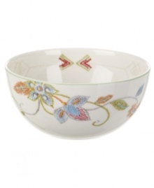 Well-crafted blooms create the illusion of texture on the sleek white porcelain of Oleg Cassini's Kavita fruit bowl. A charming complement to the dinnerware collection.