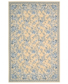 Attractive floral images make this country-style rug a delightful addition to any room. Woven from plush wool, the Country Heritage rug features a muted yellow field, speckled with beautiful blues and whites.