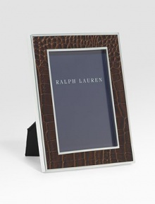 An elegant, silverplated brass frame, wrapped in alligator-embossed leather. Arrives in a gift box Accommodates a 5 X 7 photograph Overall: 7 X 9 Imported 