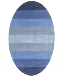 Hand-tufted, blended wool gives an exceptionally soft feel to this rug from the Coastal Treasures collection. In a shimmering, striped design of ocean-blue colorways, this sophisticated piece adds serene character to every decor.