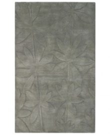 Expanding on classic rug motifs, this modern piece features a clean design of oversized leaves, virtually imprinted on an cool gray background. New Zealand wool is tufted by hand, creating a premium-quality rug with thick, dense pile.