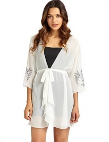 THE LOOKTailored from sheer georgetteWrap front with button closureFront tie waistThree-quarter length sleeves with floral embroidered cuffsTHE FITAbout 33 from shoulder to hemTHE MATERIALPolyesterCARE & ORIGINMachine washImported