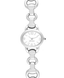 Graceful and precise, this Nine West watch is poetry in motion. Crafted of silver tone mixed metal linked bracelet and round case. White tone dial features silver tone applied stick indices, numerals at three, six, nine and twelve o'clock, silver tone hour and minute hands, sweeping second hand and logo at six o'clock. Quartz movement. Limited lifetime warranty.