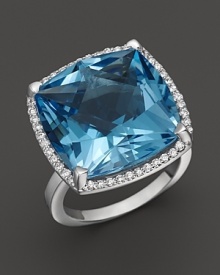 A cushion cut blue topaz is framed by diamonds in this sparkling 18K white gold ring from Lisa Nik's Rocks Collection.