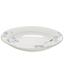 Breezy florals scatter on the white bone china of this Water Blossoms rim soup bowl, suffusing your table with effortless grace. With shimmering platinum petals and banding for an especially pretty table. From Martha Stewart Collection.