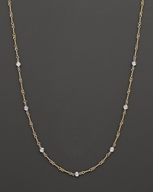 A yellow and white gold necklace with bezel-set diamond stations. With signature ruby accent. Designed by Roberto Coin.