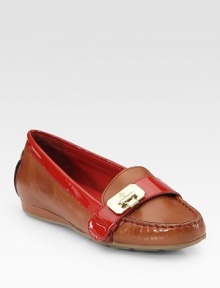 Moccasin-inspired leather with vibrant patent leather trim and a unique, hinge-adorned buckle strap. Leather and patent leather upperLeather liningRubber solePadded insoleImportedOUR FIT MODEL RECOMMENDS ordering one half size down as this style runs large. 