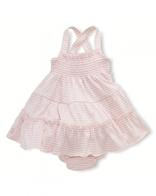 A comfortable striped cotton dress is fashioned with smocked detailing and a full ruffled skirt for girlie style.