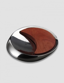 Inspired by the meeting of the sun and moon, this innovative metal alloy and cherry wood design combines a bowl and a board for both cutting and serving. Comes in Nambé blue gift box 14 Dia Hand wash gently Imported