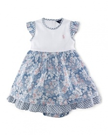 A pretty day dress is styled with a charming floral print and contrasting trim.