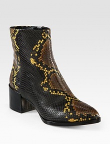 An exotic print defines this classic ankle boot crafted of textured leather with a smooth patent-covered heel. Patent leather heel, 2 (50mm)Snake-print leather upperSide zipLeather lining and solePadded insoleImported