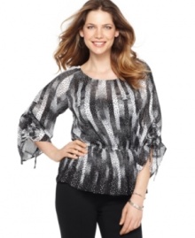 Style&co.'s petite top features a bold print and a stylish silhouette--pair with slim-fitting pants and your favorite heels for a great evening-out ensemble! (Clearance)